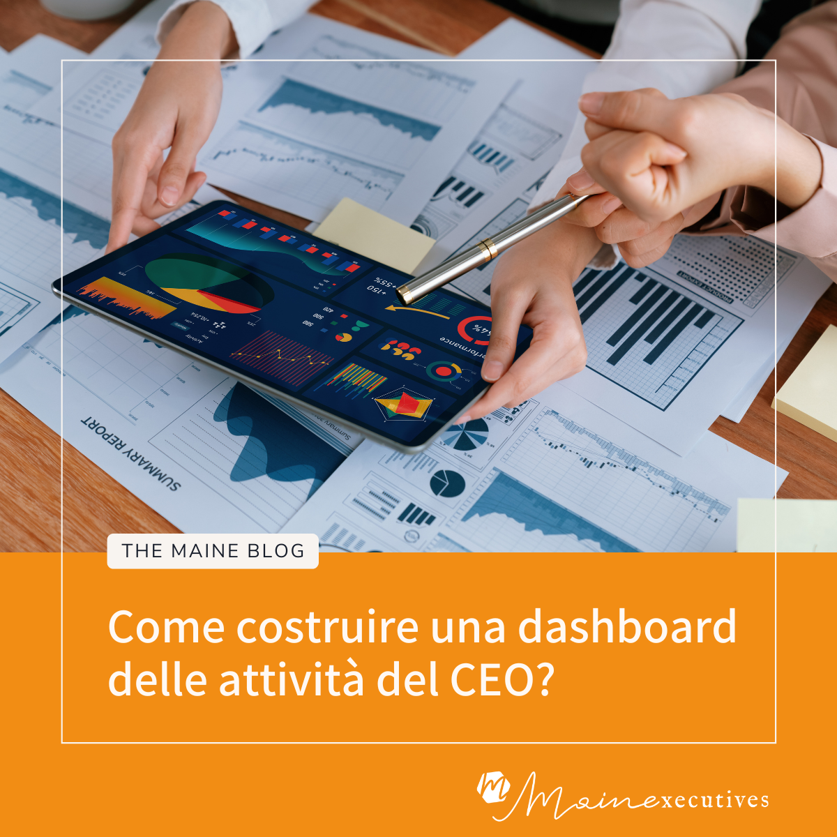 Due professionisti analizzano una dashboard digitale su un tablet con grafici e tabelle, appoggiato su documenti cartacei con dati finanziari e report